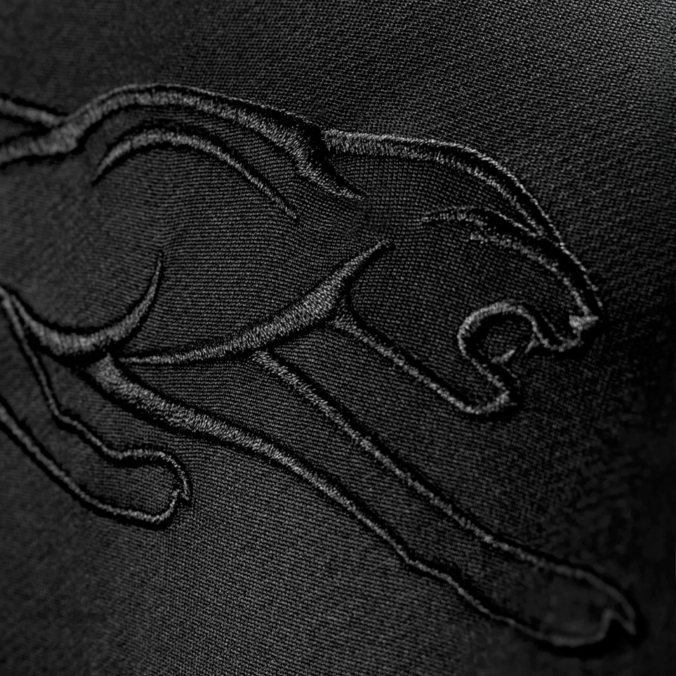 Black panther logo embroidered on a black fabric.