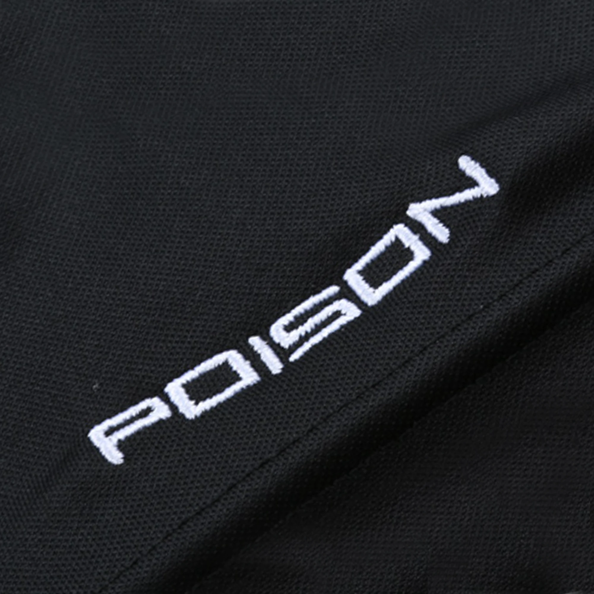 White embroidered Poison logo on black fabric background.