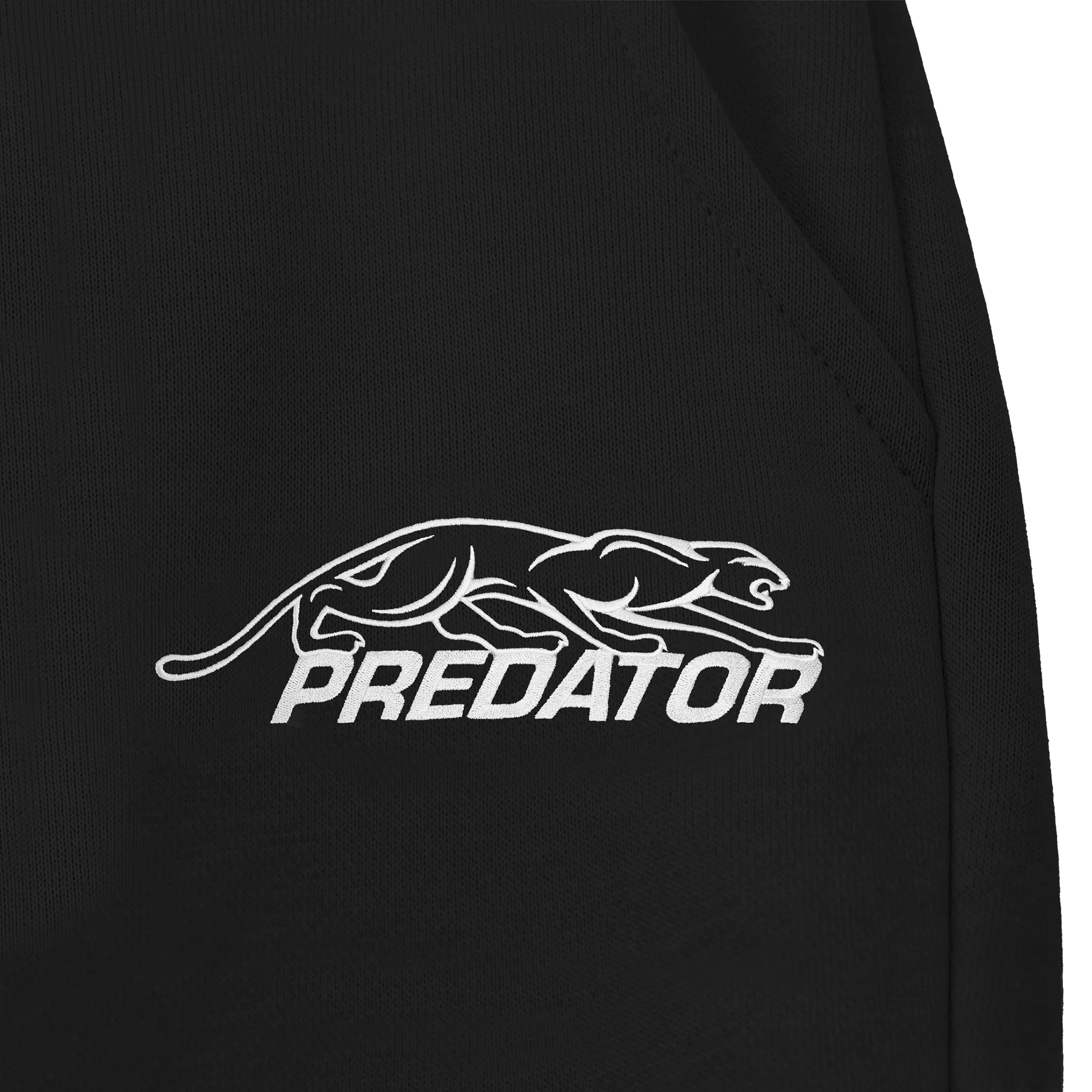 White Predator logo against a black fabric background.