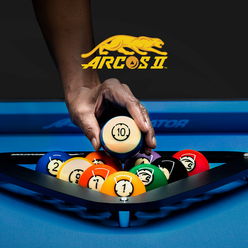 Hand holding a pool ball with Arcos II logo in the background