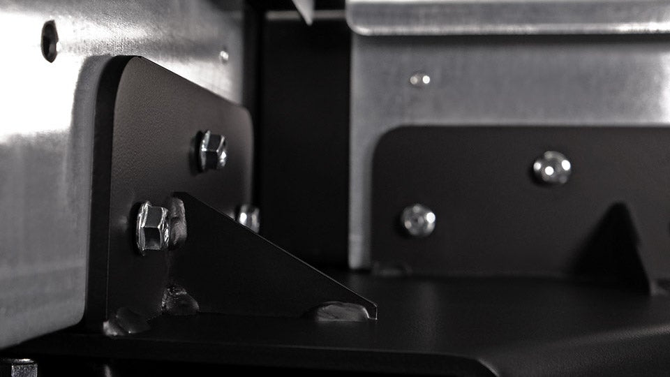 Close-up of metal brackets and screws on a mechanical or industrial component.