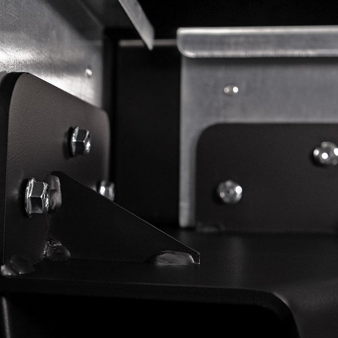 Close-up of metal brackets and screws on a mechanical or industrial component.