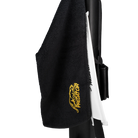 Black towel with yellow embroidered Predator logo, clipped to black and white pool cue case.