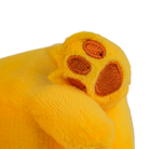 Close-up of a yellow plush toy paw with brown pads on a white background.