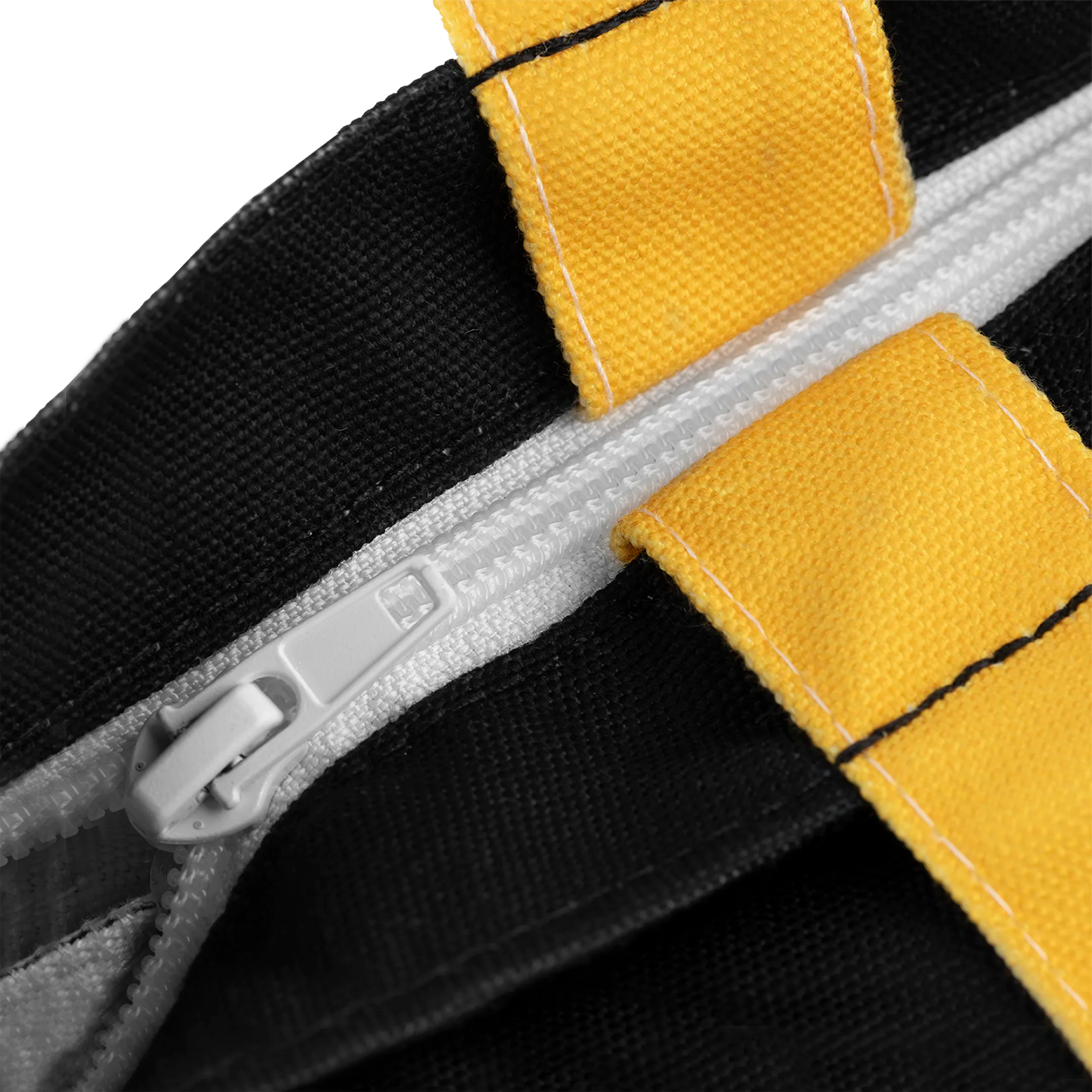 Close-up of a zipper on a black and yellow fabric background.
