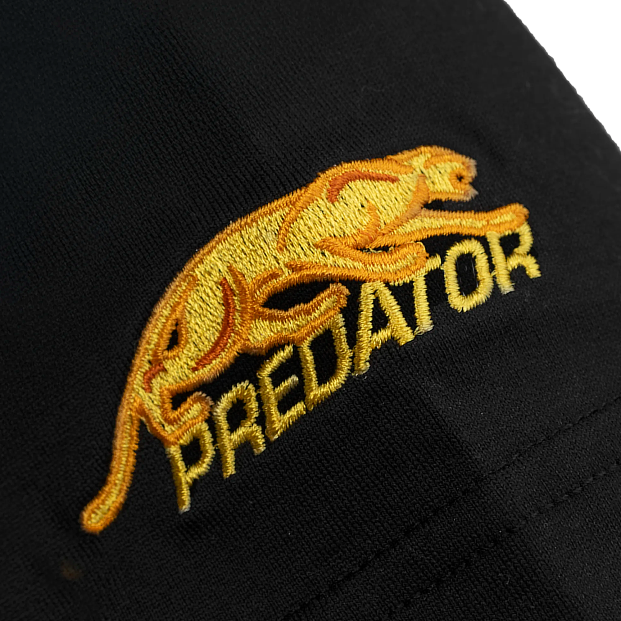 Gold embroidered logo of a leaping animal and the word 'Predator'.