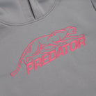 Pink embroidered Predator logo against a grey sweatshirt background.
