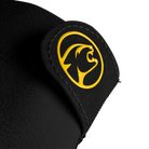 Close-up of black glove material with circular yellow cat head logo