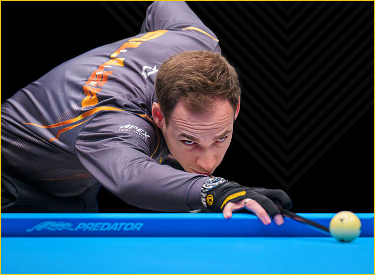 Man hitting a pool cue on a predator arcadia reserve pool table felt cloth