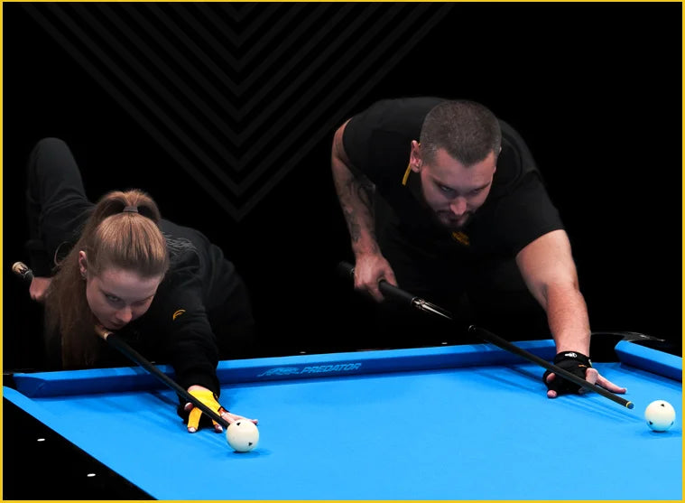 Two pro players playing pool on the blue premium Arcadia table