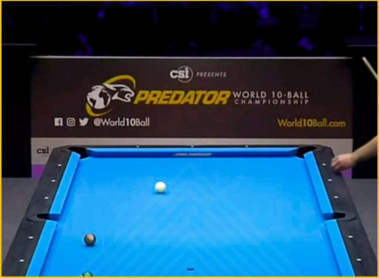 Pool table with a white ball and black ball on blue Arcadia Reserve cloth